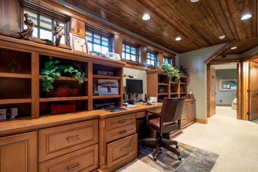 Custom built-in home office with dual workstations and upper display shelving.