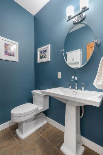 The powder room is tucked away on the main level off the mud room