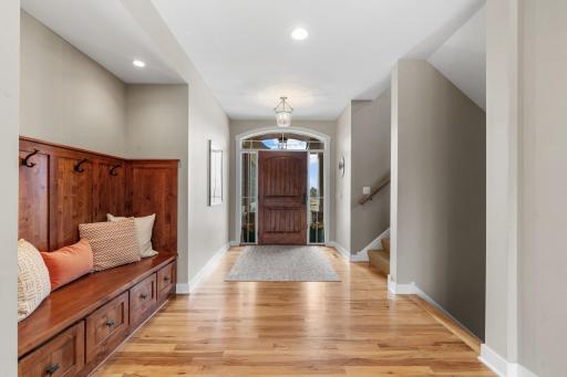 The foyer welcomes you with gleaming hardwood floors that continue throughout the main level.