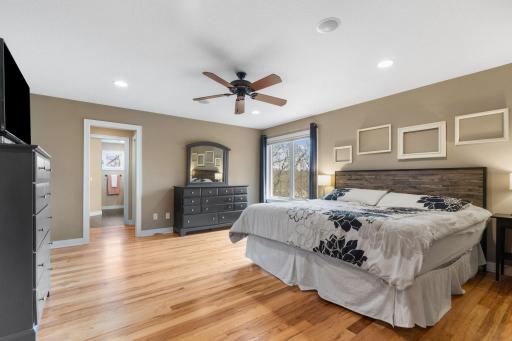 The primary bedroom suite features hardwood floors and an attached en suite.