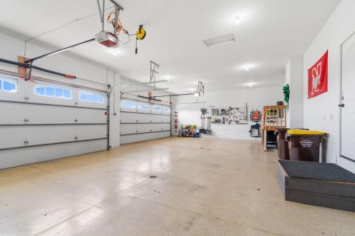 A four stall heated/insulated garage with epoxy floor, EV charging outlet and private upper level access.