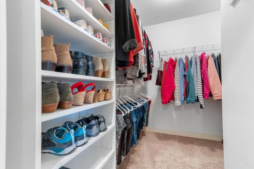 One of two walk in closets in the primary bedroom allows for ample clothing storage.