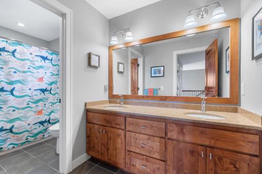 The upper level full bathroom provides a large vanity with dual sinks.