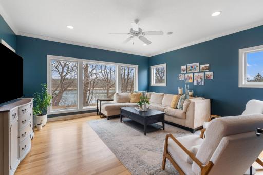 Another room filled with light through the large picture windows with views of the serene backyard.