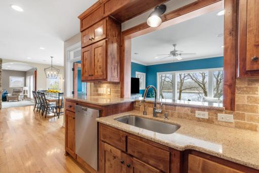 Stay in the conversation and enjoy a view of the outdoors with the open window from kitchen to sun room.