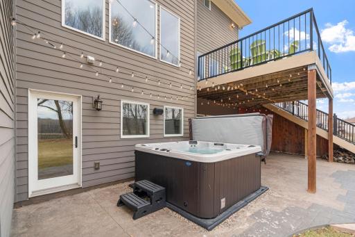 Walkout to the large stamped concrete patio with new 6-8 person hot tub.