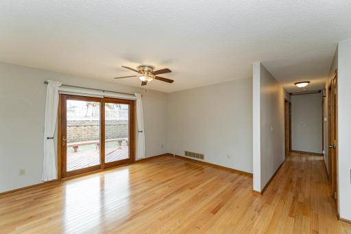 Living room with hardwood floors and deck access