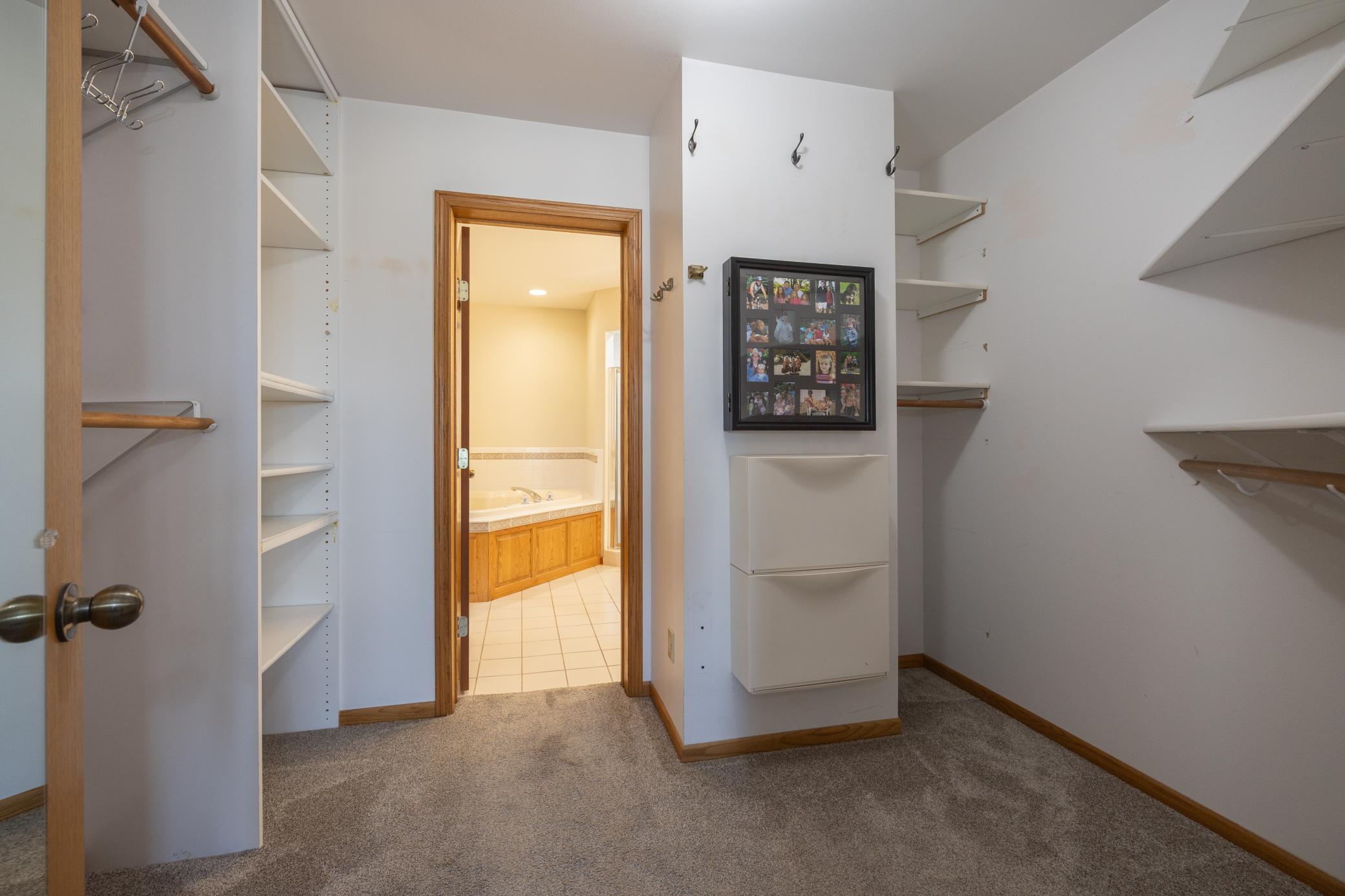 Primary bedroom walk in closet