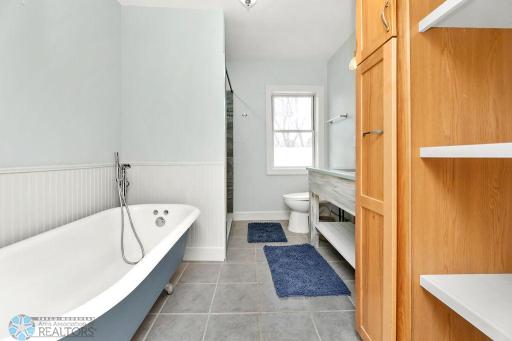 Clawfoot Tub. Linen cabinet w/ built-in shelves for storage.