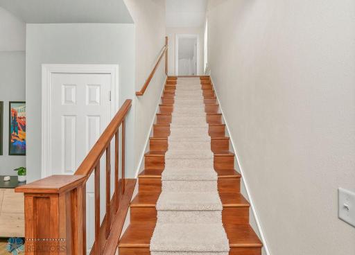 Beautiful hardwood staircase to upper landing