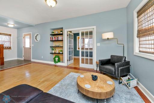 Living Room with original hardwood floors & built-in shelves