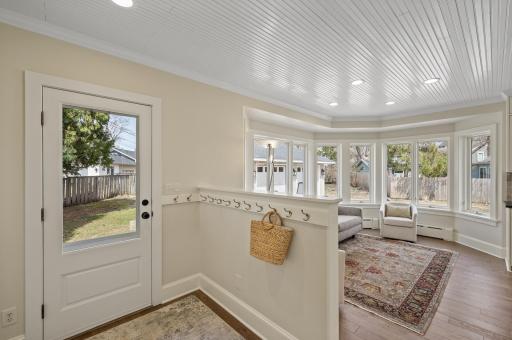 Perfect mud room area with beadboard ceiling throughout space