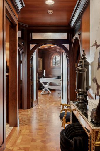 Introducing the upper level featuring two bedrooms, office, and laundry with arched doorways.