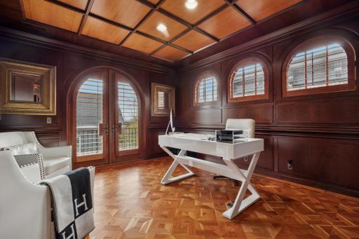 Paneled office leading out to a second floor deck.