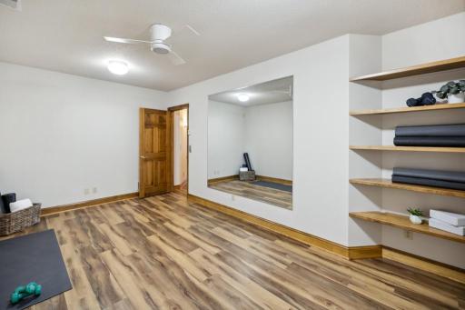 The lower-level gym offers a private, functional space to power through workouts or unwind with yoga.