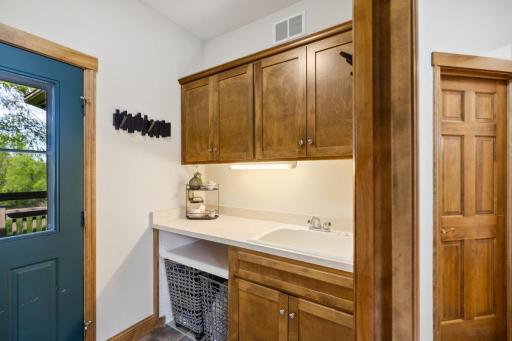 With ample cabinetry, folding counters, a deep sink, and front-load LG washer and dryer, it’s a space designed to keep the everyday running smoothly.