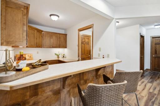The wet bar offers the perfect setup for crafting cocktails or serving up appetizers while the walkout patio draws you outdoors.