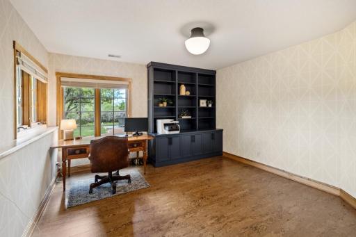 Tucked away on the lower level, this versatile office offers a quiet space to focus—with custom built-ins, cork flooring, and a view that’s anything but distracting.