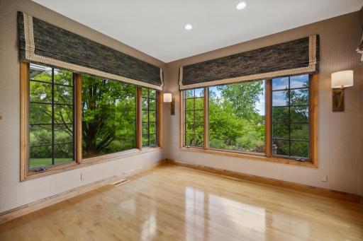 Bright and inviting, the main-level sunroom offers a versatile retreat—whether you’re unwinding with a book or hosting casual meals framed by serene golf course and pond views.