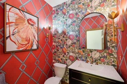 The main floor powder room proves that small spaces can still make a statement. Bold wallpaper, custom lighting, and elevated finishes create a moment of design that’s anything but an afterthought.