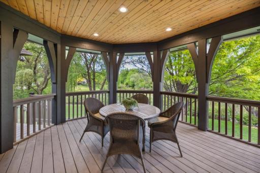 Just steps from the kitchen, the screened porch extends your living space outdoors, providing a comfortable, bug-free retreat.