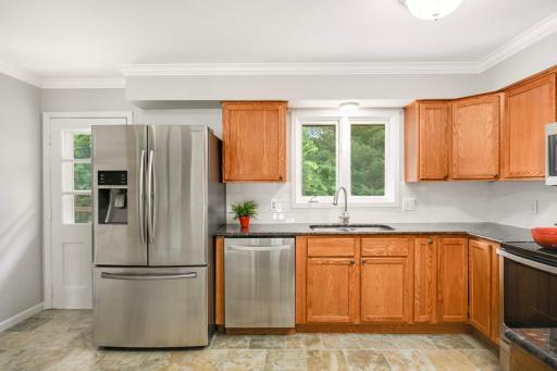 Kitchen with new subway tile backsplash. The door leads to the deck.