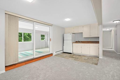 Family room has a beverage bar with refrigerator and sink. Off the family room is an enclosed porch.