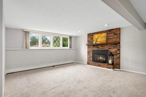 Large family room with new carpeting and gas burning fireplace.