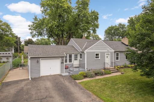Charming 1946 rambler with fiber cement siding, attached garage, and classic curb appeal on Edgewater Ave.