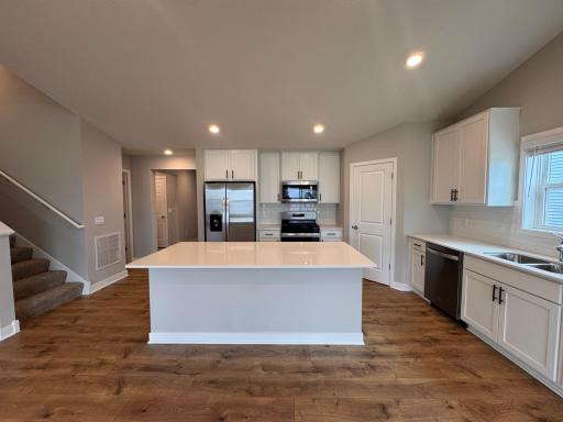 Kitchen - quartz countertops, vented fan to outside, gas cooktop, and walk-in pantry
