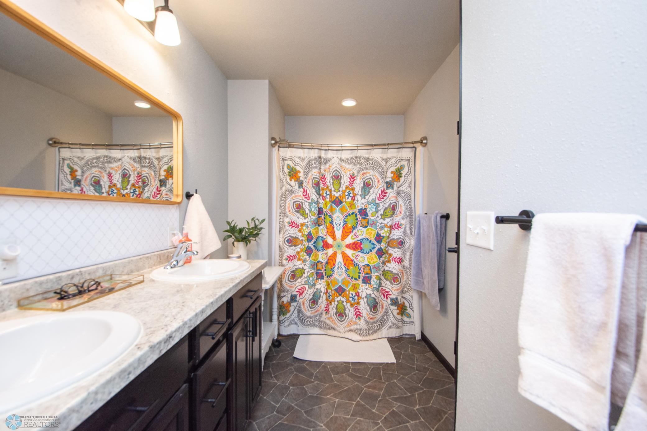 primary full bathroom w/ double vanity sinks