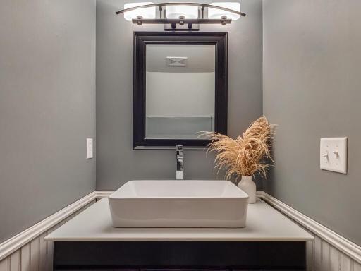 The half-bath/powder room has been remodeled with modern touches.