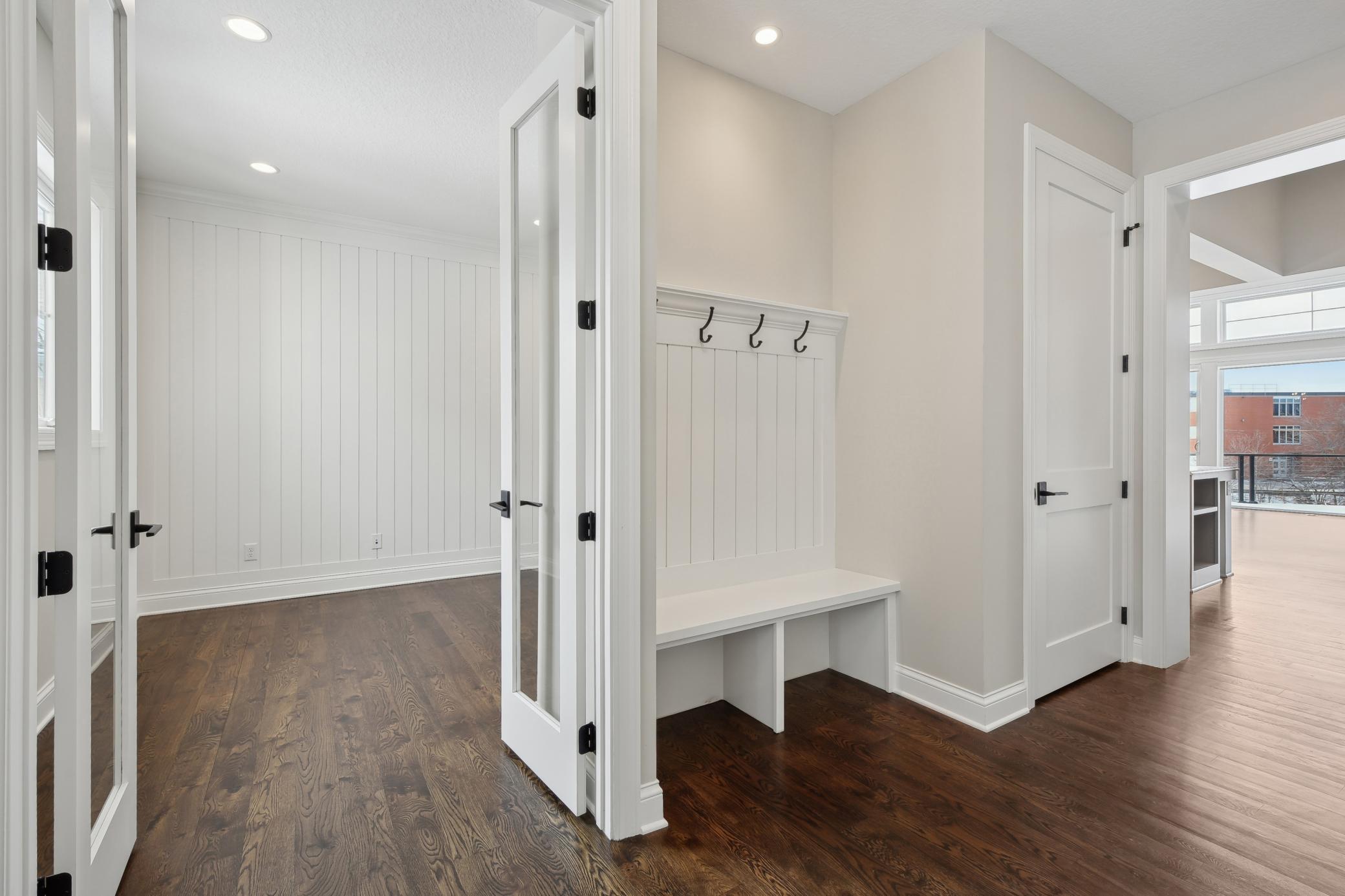 The front entrance features a built-in bench with hooks and a large front closet. The closet doubles as an elevator shaft, ready for the upgrade for those who need it!
