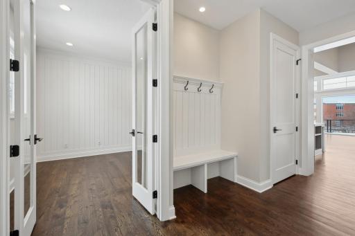 The front entrance features a built-in bench with hooks and a large front closet. The closet doubles as an elevator shaft, ready for the upgrade for those who need it!