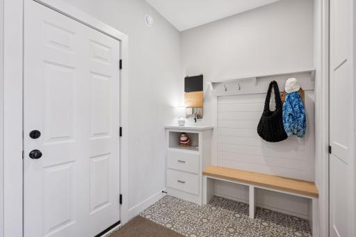 The mudroom is a practical, well-designed space with easy access to the garage, featuring a closet for convenience.