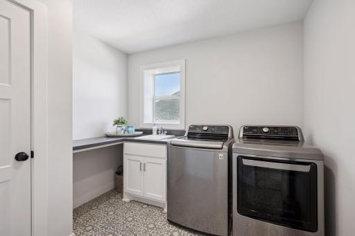 The laundry room is conveniently located upstairs adjacent to the primary bedroom.