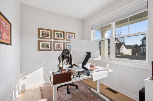 The main floor office offers wood flooring, a double window (Pella windows throughout), and recessed lighting for a clean, modern look.