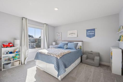 The second guest room features a large window, plush carpeted flooring, double closet and access to a full jack and jill bath.