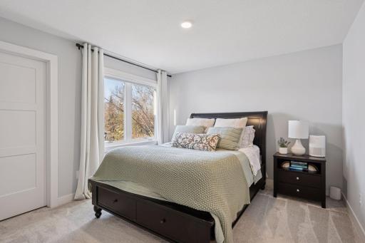 An upstairs guest bedroom welcomes you with plush carpeting, walk in closet, double window, recessed lighting and a private 3/4 bath.