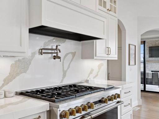 The six-burner, double oven range anchors the space.