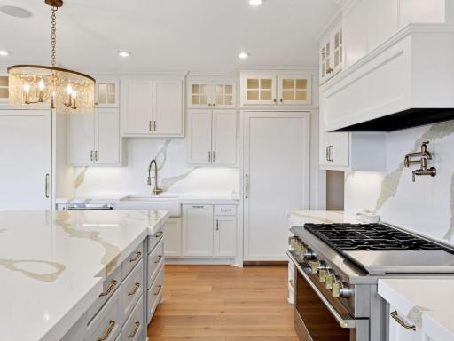 Premium appliances take this chef's kitchen to the next level. Dual paneled refrigerator and freezer streamline this design while offering ample storage.