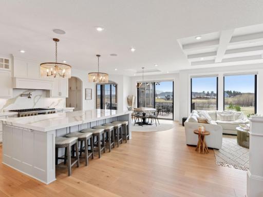 The open-concept main floor wows with beamed ceilings, gorgeous white oak flooring and a fantastic chef's kitchen.