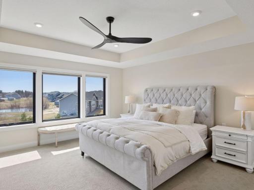 The primary suite is a show-stopper, with a recessed tray ceiling, large windows and a stunning bath + walk-in closet ensuite.