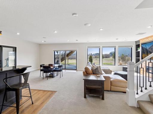 The lower level is an entertainer's dream - floor-to-ceiling windows make this space feel like a main level living area!
