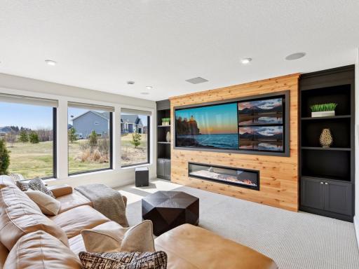 The custom buit-ins host multiple TV's and an electric fireplace.