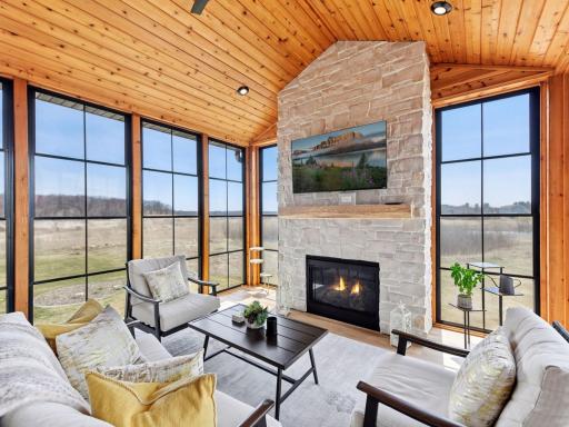 The three-season porch boasts a gas fireplace, vaulted ceilings and panoramic views.