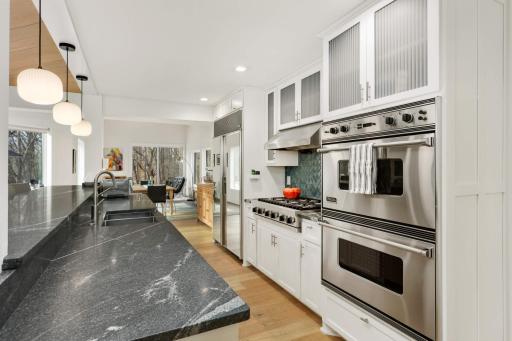 Luxury appliances including double oven, gas cooktop with range hood and built in refrigerator