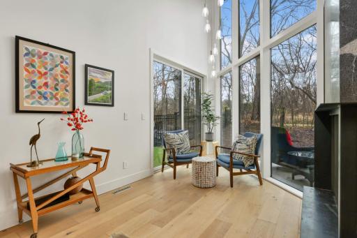 Sunroom has 2 story windows and patio door