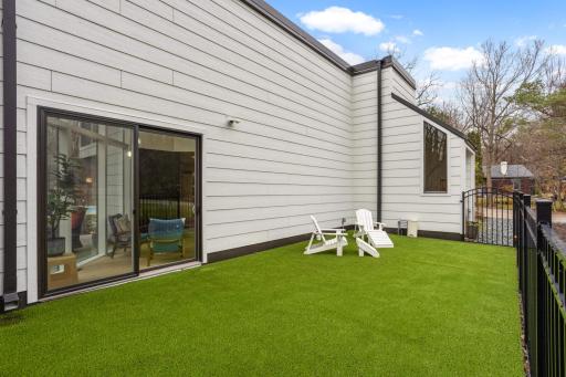 Fenced in pet turf area, could be covered to pavers