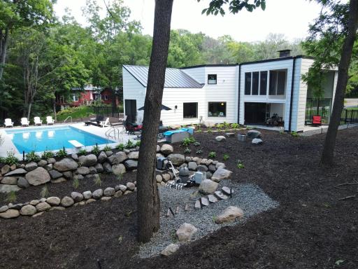 Pool equipment was designed to be out of the way. Stairs lead to fire pit and creek
